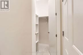 Ottawa townhouse for rent - A white hallway with a door on the right and a closet with shelves on the left.