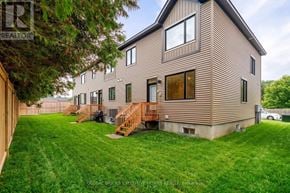 Ottawa townhouse for rent - A house with a brown facade and a green lawn in front.