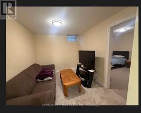 Toronto (Highland Creek) apartment for rent - A living room with a couch, coffee table, and television.