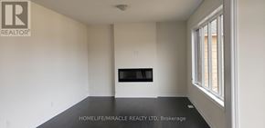 Wasaga Beach apartment for rent - A large empty room with a fireplace and a window.