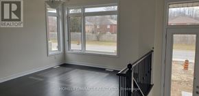 Wasaga Beach apartment for rent - A room with a window and a view of a construction site outside.