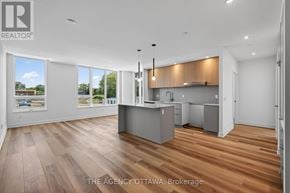 Ottawa condo for rent - A well-lit, spacious kitchen and living room with wooden flooring and large windows.