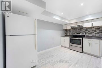 Mississauga (Erindale) apartment for rent - A kitchen with white cabinets and a stone backsplash.