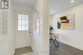 Brampton (Credit Valley) multi-family for rent - A hallway with a white door and a painting on the wall.