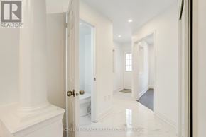 Brampton (Credit Valley) multi-family for rent - A white hallway with a door on the left and a mirror on the right.