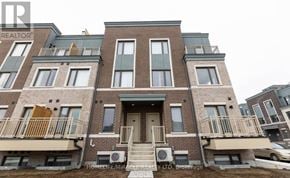 Toronto (New Toronto) townhouse for rent - A building with a balcony and a door in the center.