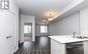 Toronto (New Toronto) townhouse for rent - A white kitchen with a sink and a dishwasher.