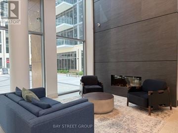Milton (Tm Timberlea) condo for rent - A living room with a blue couch and a television.