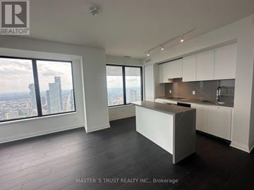 Mississauga (City Centre) condo for rent - A spacious kitchen and living room with a view of the cityscape.