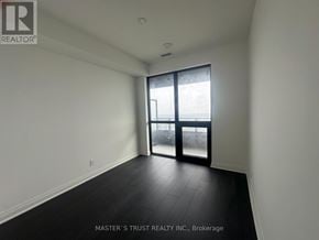Mississauga (City Centre) condo for rent - A room with a sliding glass door leading to a balcony.