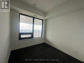 Mississauga (City Centre) condo for rent - A room with a window that has a view of a city.