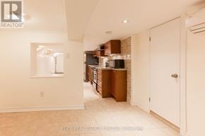 Toronto (Palmerston-Little Italy) apartment for rent - A hallway with a white door and a brick wall in the background.