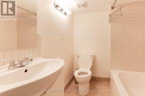 Toronto (Palmerston-Little Italy) apartment for rent - A white bathroom with a toilet, sink, and bathtub.