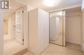 Toronto (Palmerston-Little Italy) apartment for rent - A bedroom with a white door and a large mirror.