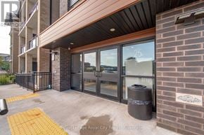 Guelph (Pineridge/Westminster Woods) condo for rent - The image shows the front of a building with a glass door and a sign that reads "Royal LePage Royal City Realty Brokerage."