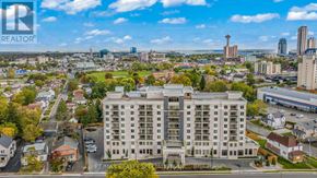 Niagara Falls (Hospital) condo for rent - A large building with a parking lot in front of it.