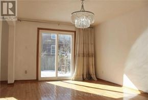 Toronto (L'amoreaux) apartment for rent - A room with a large window and a chandelier.