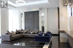 Markham (Wismer) condo for rent - A modern living room with a grey sofa and a glass table.