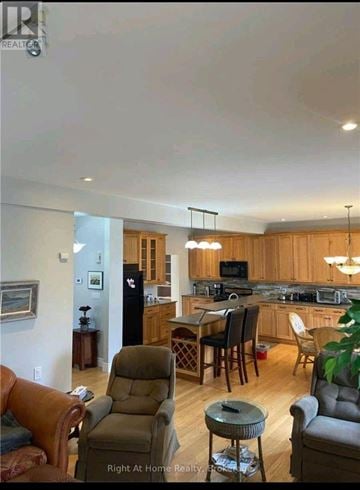 Clarington (Bowmanville) apartment for rent - A living room with a brown leather chair and a wooden table.
