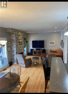 Clarington (Bowmanville) apartment for rent - A living room with a stone pillar and a flat screen TV.