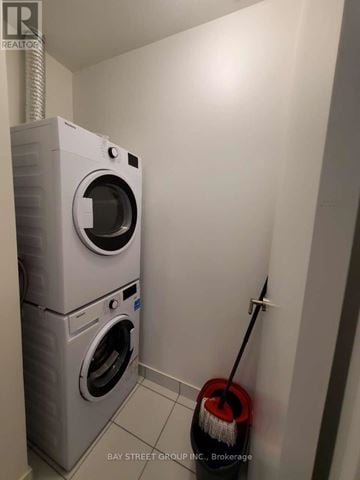 Toronto (Henry Farm) condo for rent - A white washing machine and dryer in a small laundry room.