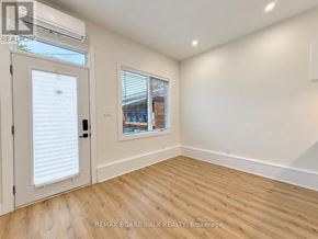 Ottawa fourplex for rent - A room with a door and a window with blinds.