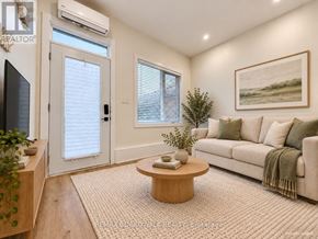 Ottawa fourplex for rent - A living room with a couch, a coffee table, and a painting on the wall.