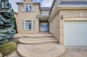 Markham (Cachet) apartment for rent - A house with a garage and a tree in front.