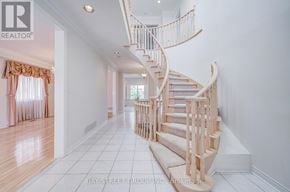 Markham (Cachet) apartment for rent - A white hallway with a spiral staircase and a window with curtains.