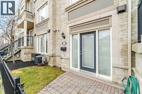 Mississauga (Churchill Meadows) townhouse for rent - A building with a balcony and a hose on the ground.