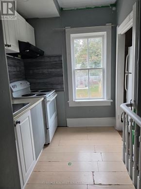 Cambridge fourplex for rent - A kitchen with a window and a washing machine.