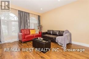 Brampton (Central Park) apartment for rent - A living room with a red chair and a black couch.