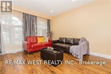 Brampton (Central Park) apartment for rent - A living room with a red chair and a black couch.