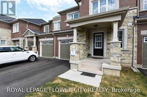 Milton (Fo Ford) townhouse for rent - A white car is parked in front of a house with a sign that says Royal LePage Flower City Realty, Brokerage.