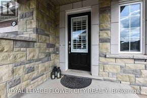 Milton (Fo Ford) townhouse for rent - A house entrance with a black door and a stone wall.