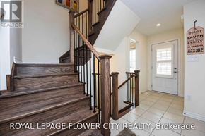 Milton (Fo Ford) townhouse for rent - A wooden staircase with a metal railing in a house.