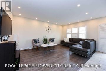 Milton (Fo Ford) townhouse for rent - A living room with a black couch and a wooden floor.