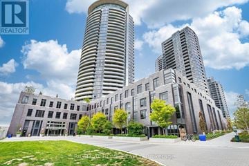 Toronto (Islington-City Centre West) condo for rent - A modern building complex with a tall cylindrical building in the background.