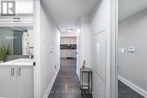 Toronto (Islington-City Centre West) condo for rent - A hallway with a white door and a plant in a pot.