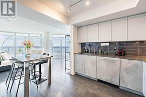 Toronto (Islington-City Centre West) condo for rent - A modern kitchen with a dining table and chairs.