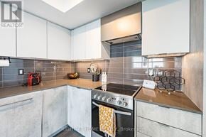 Toronto (Islington-City Centre West) condo for rent - A modern kitchen with a stove top oven and a range hood.