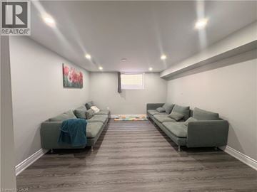 Hamilton apartment for rent - A living room with two grey couches and a painting on the wall.