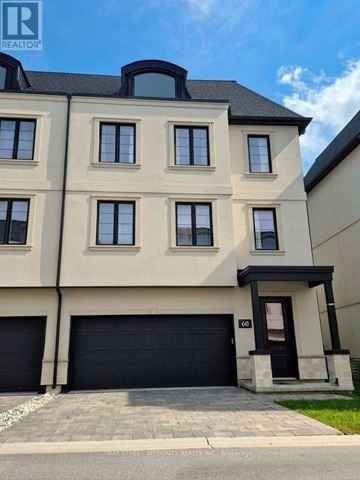 London North (North R) house for rent - A modern two-story building with a black garage door and a balcony on the second floor.