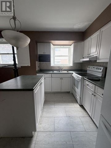 London East (East I) apartment for rent - A kitchen with white cabinets and a black counter top.