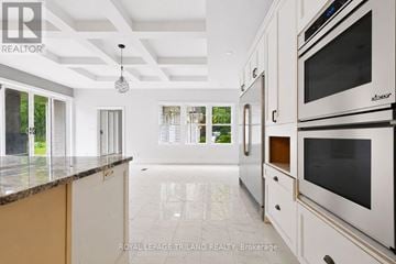 London South (South R) apartment for rent - A modern kitchen with white cabinets and a marble countertop.