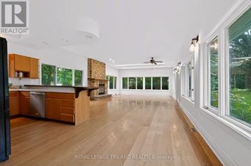 London South (South R) apartment for rent - A spacious kitchen with wooden floors and a ceiling fan.