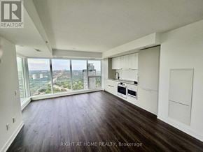 Toronto (North St. James Town) house for rent - A spacious room with wooden floors and a large window overlooking a cityscape.