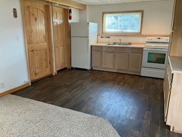 Mosinee apartment for rent - A kitchen with a refrigerator, oven, and microwave.
