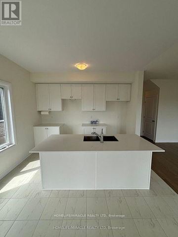 Loyalist (Bath) apartment for rent - A white kitchen with a sink and cabinets.