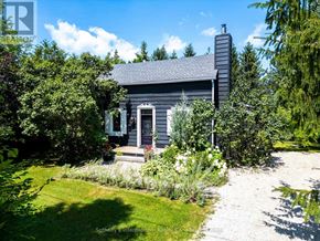 Blue Mountains apartment for rent - A small house with a grey roof and a chimney is surrounded by greenery.